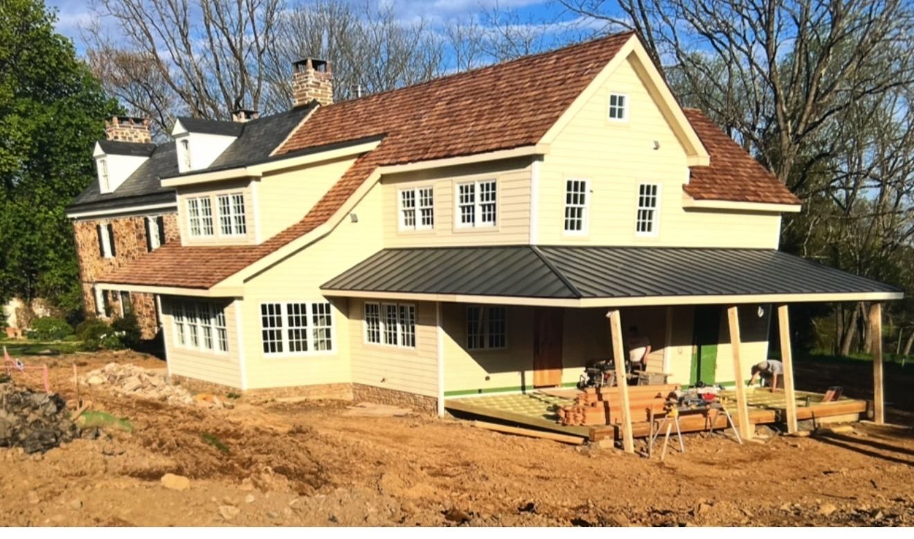 New construction farmhouse with cedar shake and standing seam metal roofing